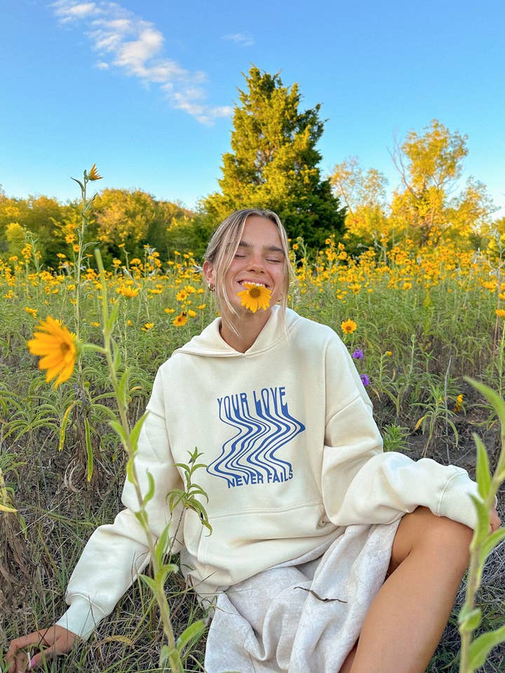 Love Never Fails Cream Unisex Hoodie for wholesale by Elevated Faith