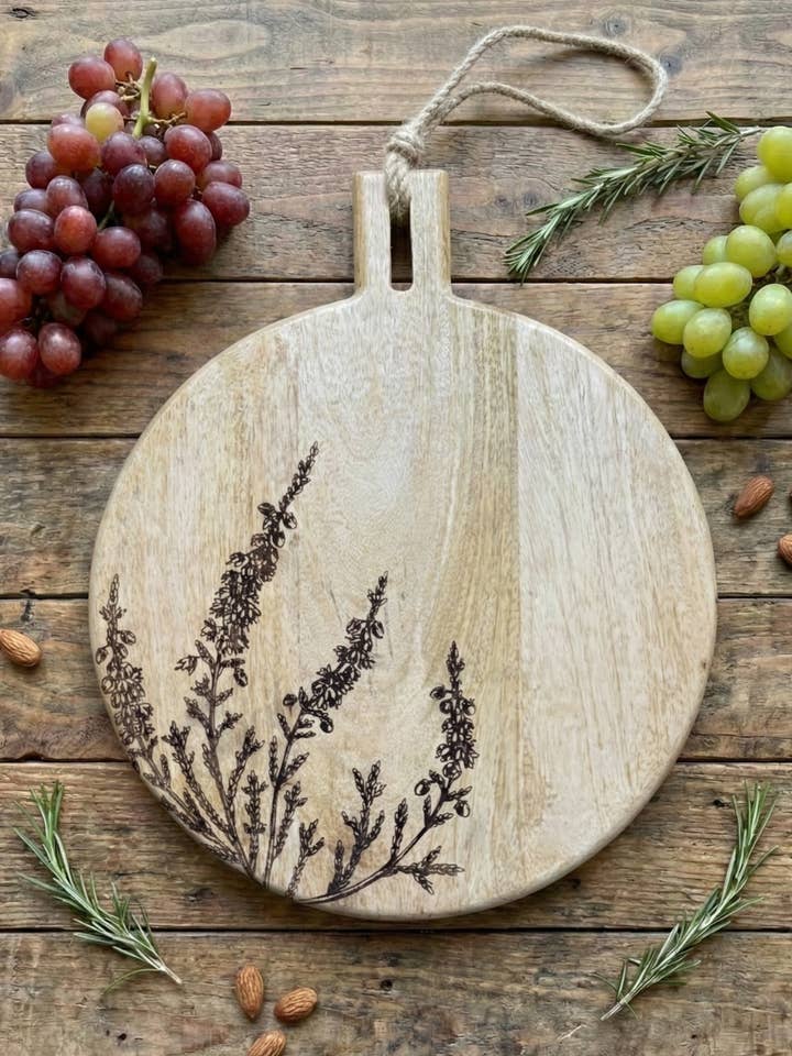 11" Floral Laser Engraved Round Mango Wood Cutting Board for wholesale by House of Wren