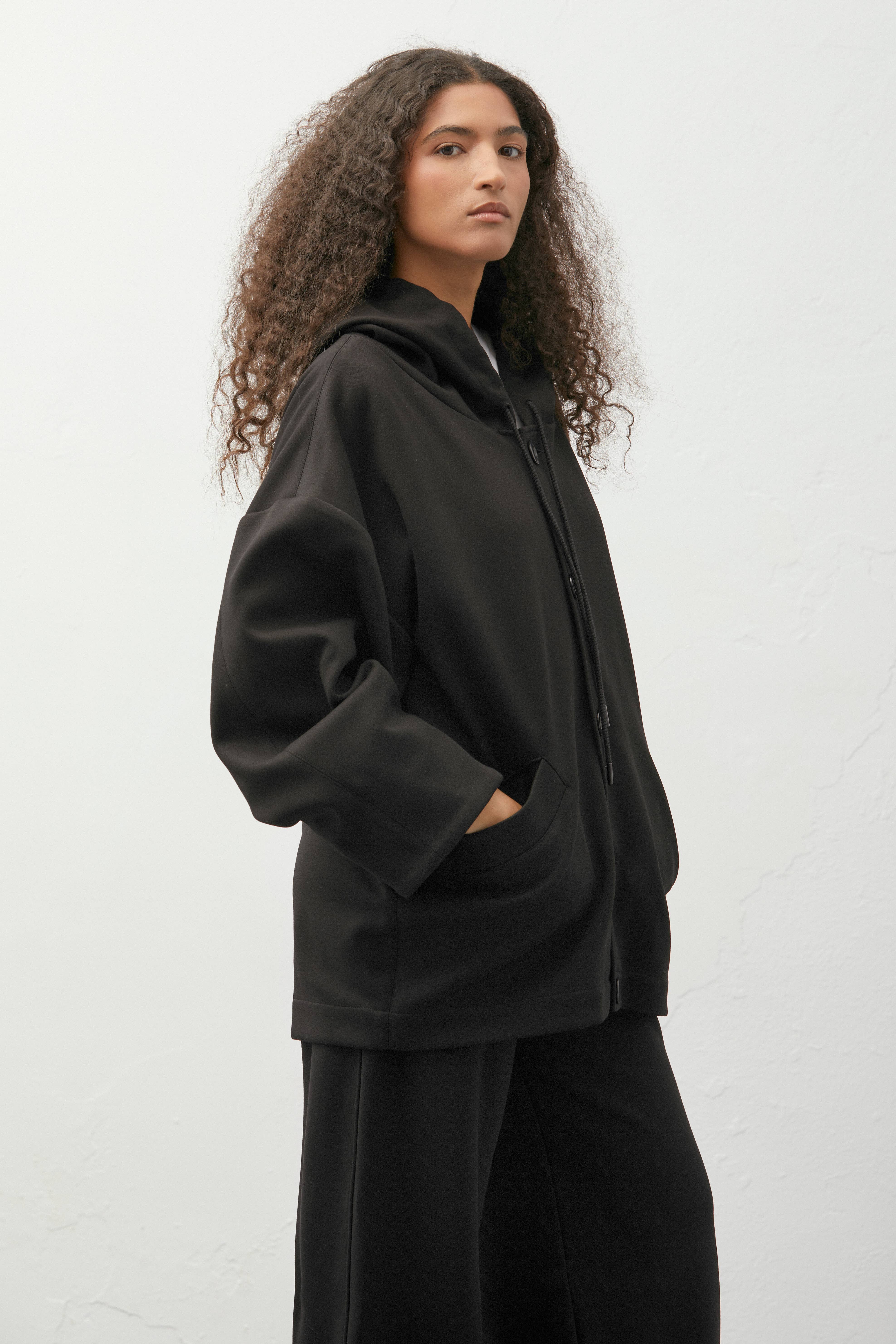 Nero Giacca oversize con cappuccio e dettaglio cordoncino in vendita all'ingrosso su Faire1