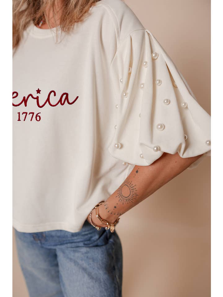 White LDC America EST 1776 Embroidered Pearl Beaded T Shirt for wholesale on Faire