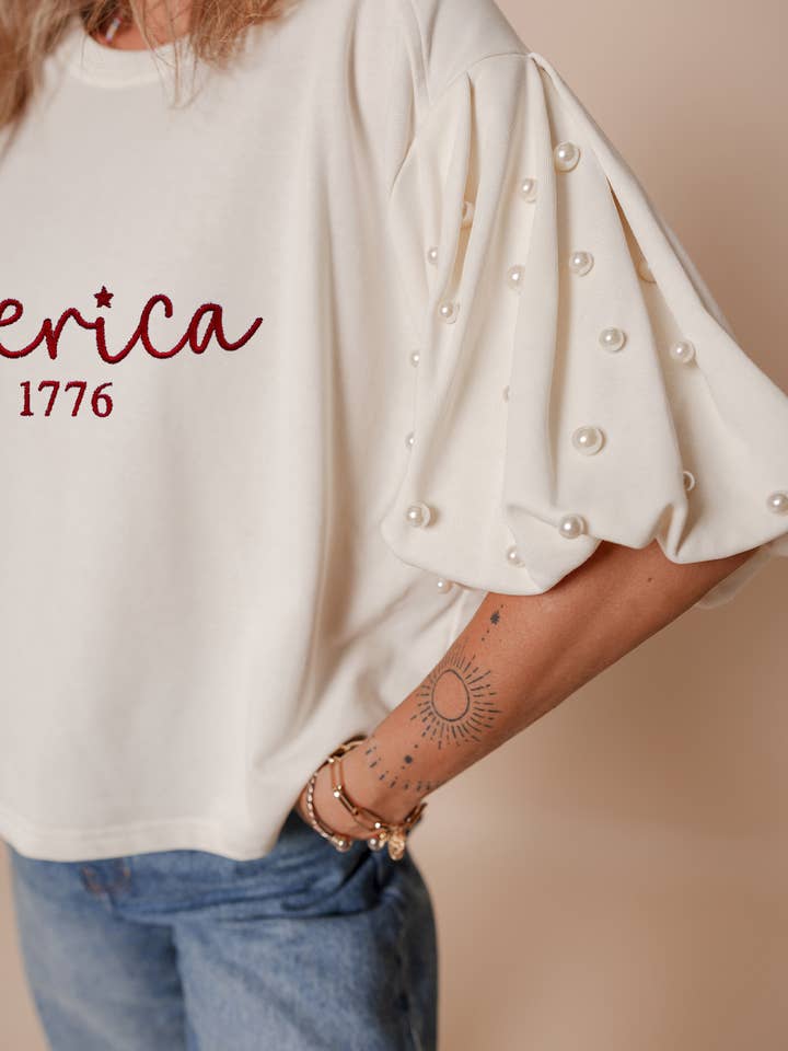 White America EST 1776 Embroidered Pearl Beaded Sleeve T Shirt for wholesale on Faire0