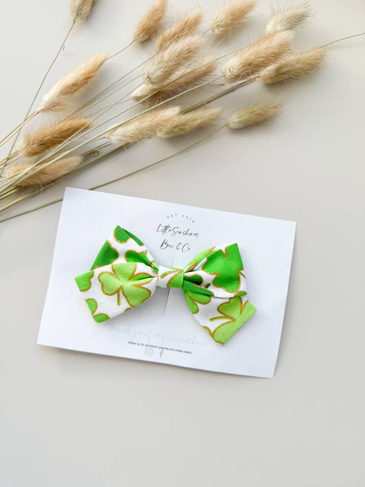White & Gold Sparkle Clovers St Patricks Day Pinwheel Bow for wholesale by Little Sunshines Bow & Co