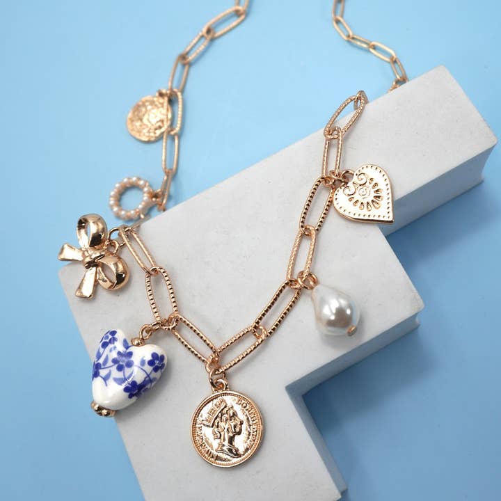 CERAMIC PORCELAIN BOW HEART CHARM LINK NECKLACE | 80N91547 and other Purchase Wholesale componenti bigiotteria. Free Returns & Net 60 Terms on Faire trending on Faire.