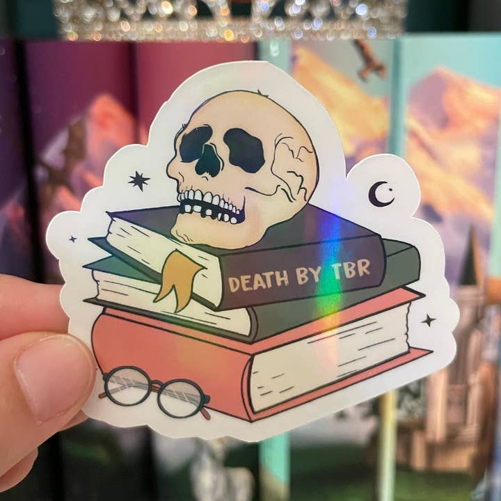 Death by TBR Book Stack Skull Rainbow Holographic for wholesale by Treasured Tropes Paper Co