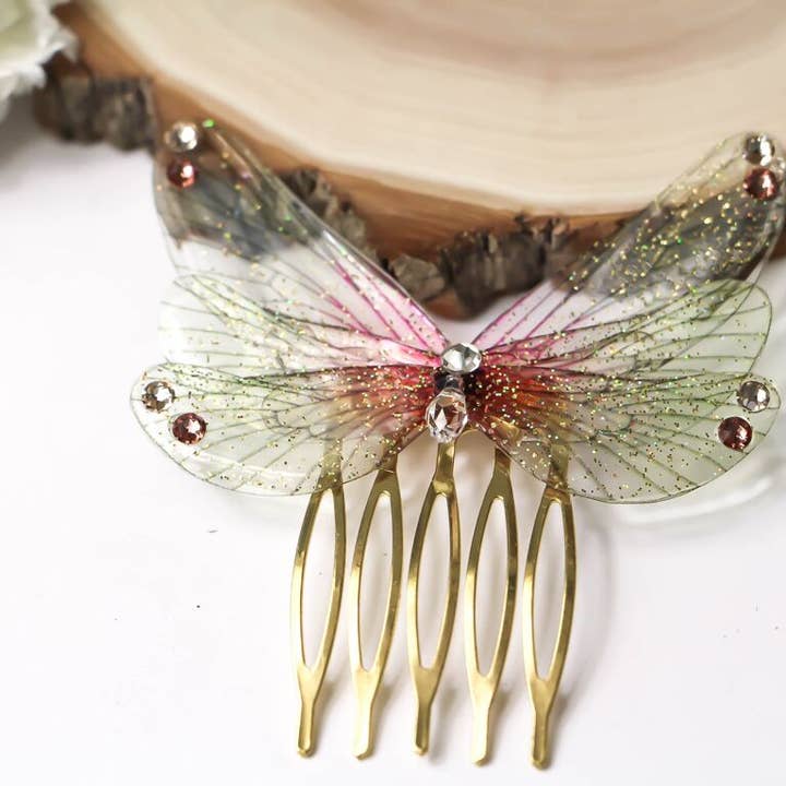 Fermaglio incantato con ali di fata sfumate e glitter per la vendita all'ingrosso da parte di Faërie