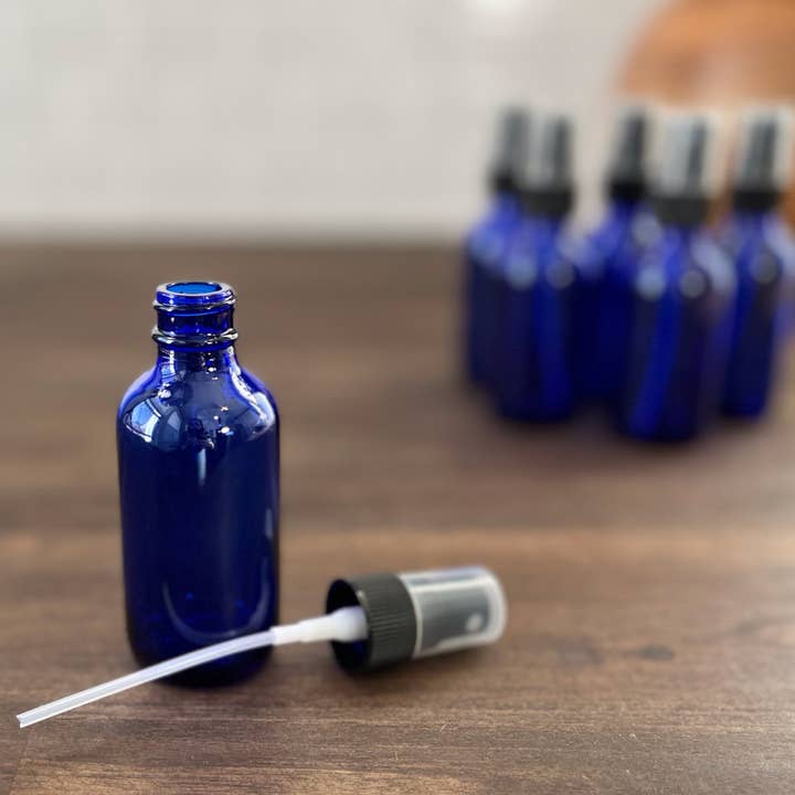 2oz Cobalt Blue Glass Bottle with Black Mist Sprayer for wholesale by The Bottle Shoppe