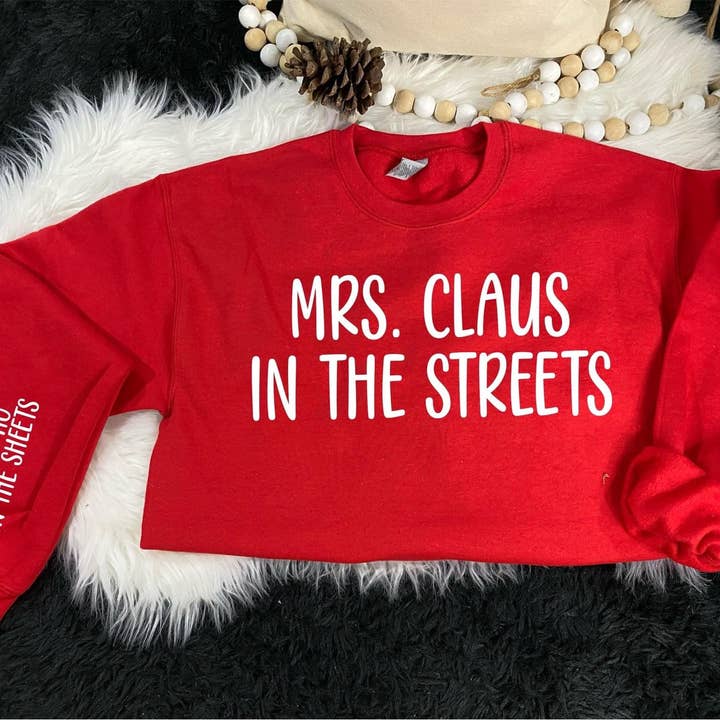 Red Mrs. Claus In The Streets With Printed Sleeve Fleece for wholesale on Faire