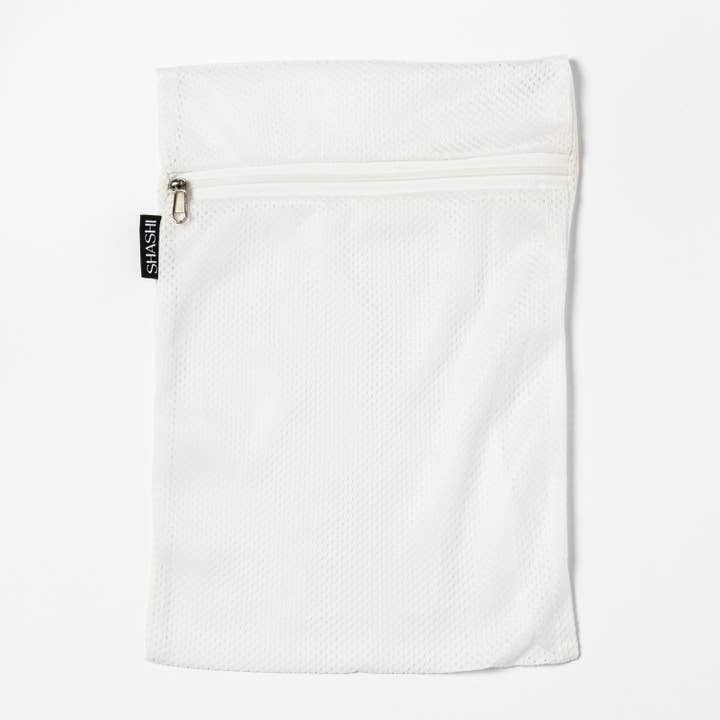 White SHASHI Laundry Bag for wholesale on Faire