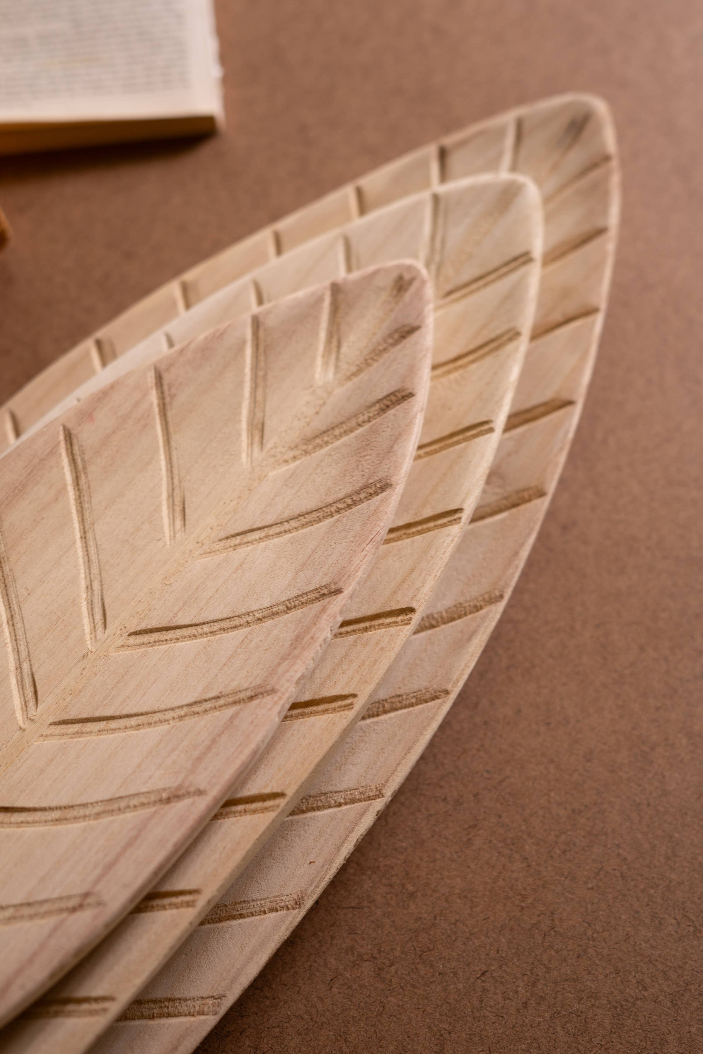 Natural SET OF THREE WOODEN LEAF TRAYS  for wholesale on Faire5