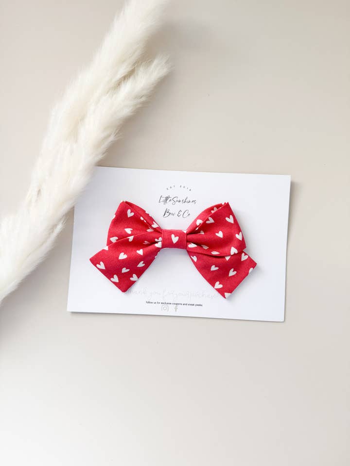 Red Hearts Valentines Day Pinwheel Bow for wholesale by Little Sunshines Bow & Co