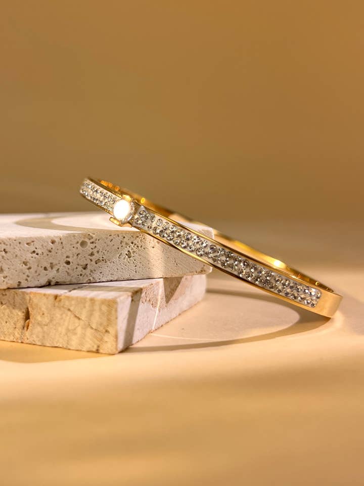 Stainless steel bangle bracelet with rhinestones & central crystal for wholesale by COSMOS