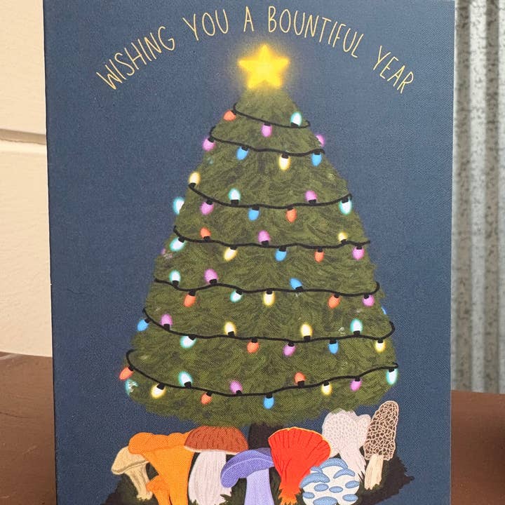 Wishing you a Bountiful Year Card with Edible Mushrooms Under the Christmas Tree and other Purchase Wholesale a brighter year. Free Returns & Net 60 Terms on Faire trending on Faire.