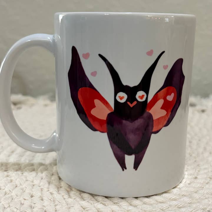 Cute Pink and Purple Mothman Hearts Art 110z Ceramic Mug for wholesale by Cryptic Paper Co.