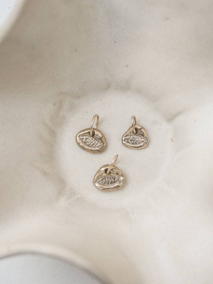 fish charm | organic stamped charm | bronze for wholesale by Emily Hartwell