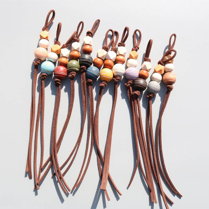 Ornaments- leather rope wooden beads keychain charm for wholesale by Eagle Crest Industries Inc.