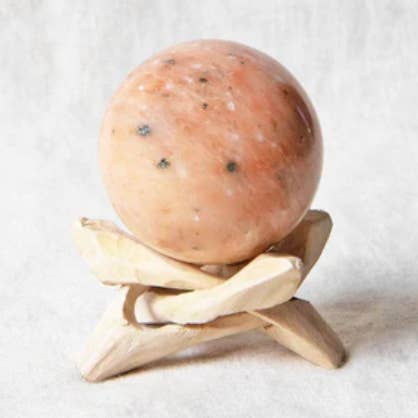 Orange Calcite Sphere with Tripod for wholesale by Tiny Rituals