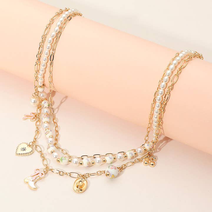 Sensibling Corp. - Wholesale Pendant/Charm Necklace - Western Cowboy Boot Hat Bow Cherry Heart Charm Station Pearl Floral Ceramic Ball Beaded Layered Necklace