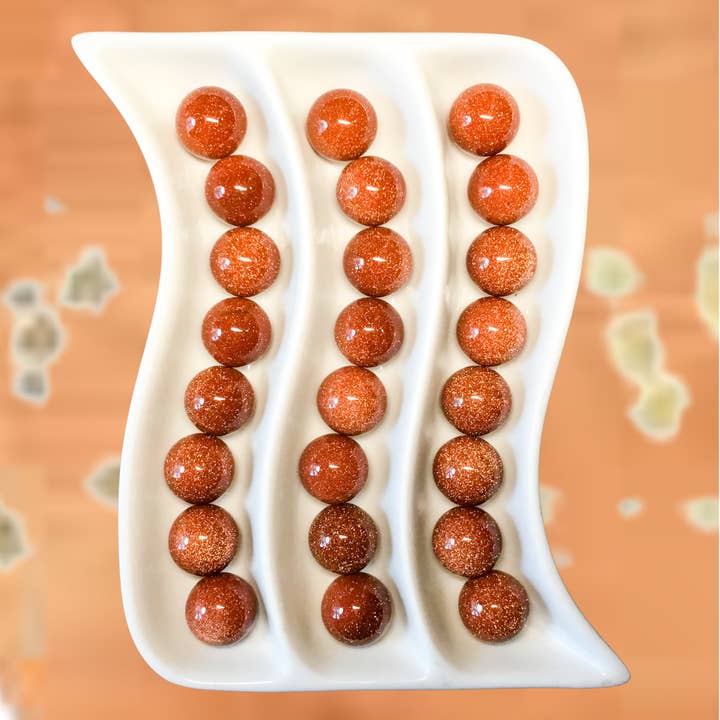 GOLDSTONE 20mm Ædelstenssfærer - Informationskort tilgængeligt for engroshandel hos Essential Wellness - Body, Mind, Spirit