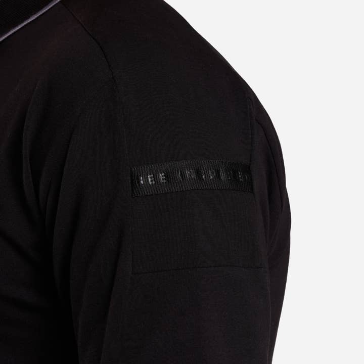 Dusan Polo Shirt - Black with Branded Overarm Tape for wholesale on Faire