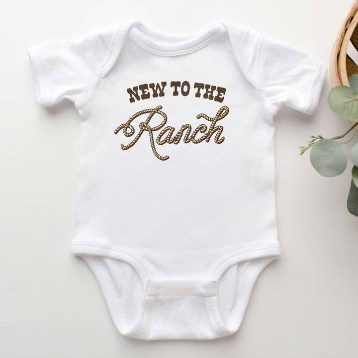 New To The Ranch Infant Onesie, Western Baby Rib Bodysuit for wholesale by Peculiar People Designs