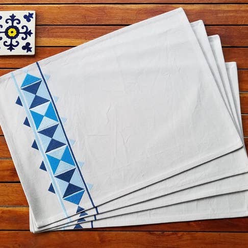 Cotton placemats embroidered with blue triangles on the side for wholesale by Indigostep
