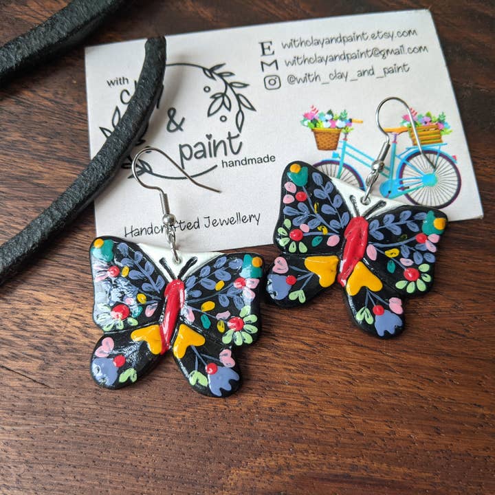 Butterfly earrings, black butterflies with hand painted flow for wholesale by With Clay & Paint