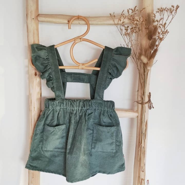 “Anna” ruffled strap skirt in emerald green corduroy for wholesale by Les p'tites Merveilles de Bérénice