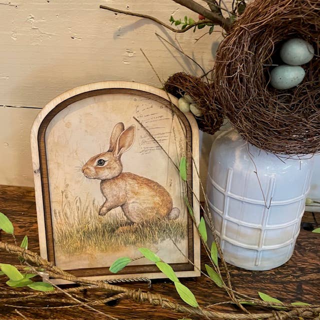 Bunny in field of grass canvas in Small Arch Frame for wholesale by LAND OF COTTON