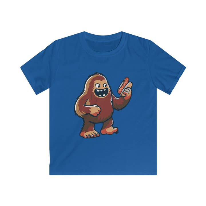 Missing Link Kids Tee — Playful Sasquatch Cartoon Holding a Hotdog Graphic Tee for wholesale by Drink in Nature