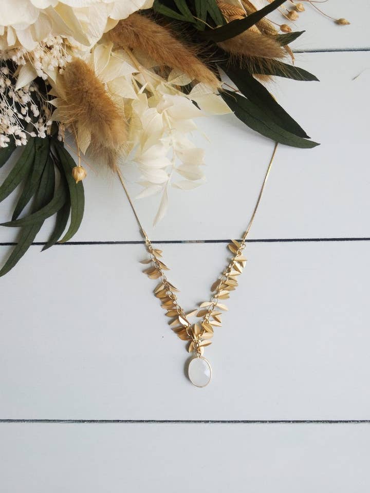 Necklace golden leaves and white oval faceted pendant for wholesale by LES TISSAGES DE CAMILLE