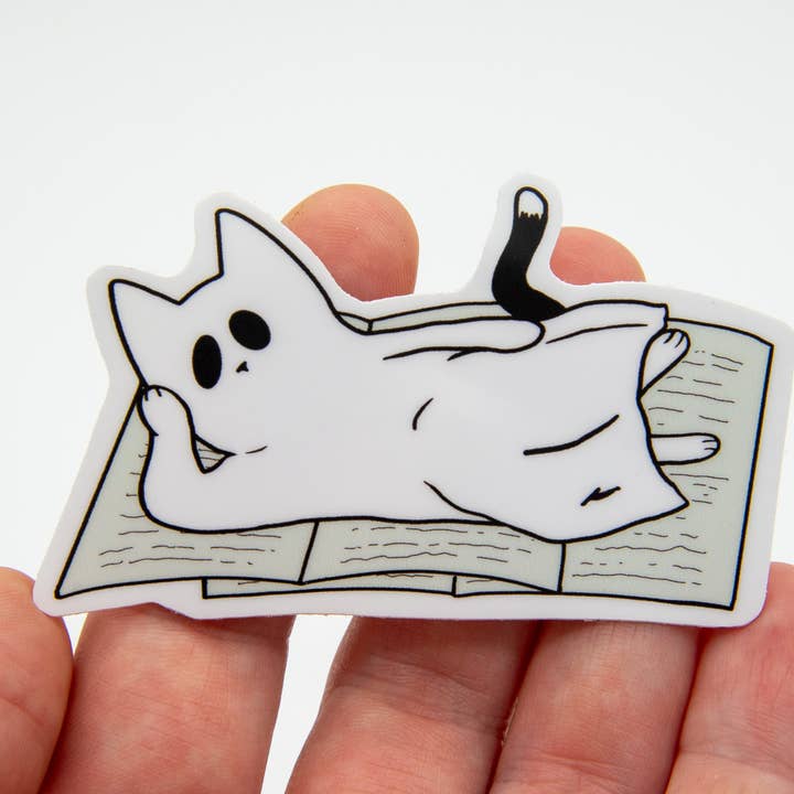 "Bookworm" the Ghost Cat Relaxing Vinyl Sticker for wholesale by Jennifer Schiano Studio