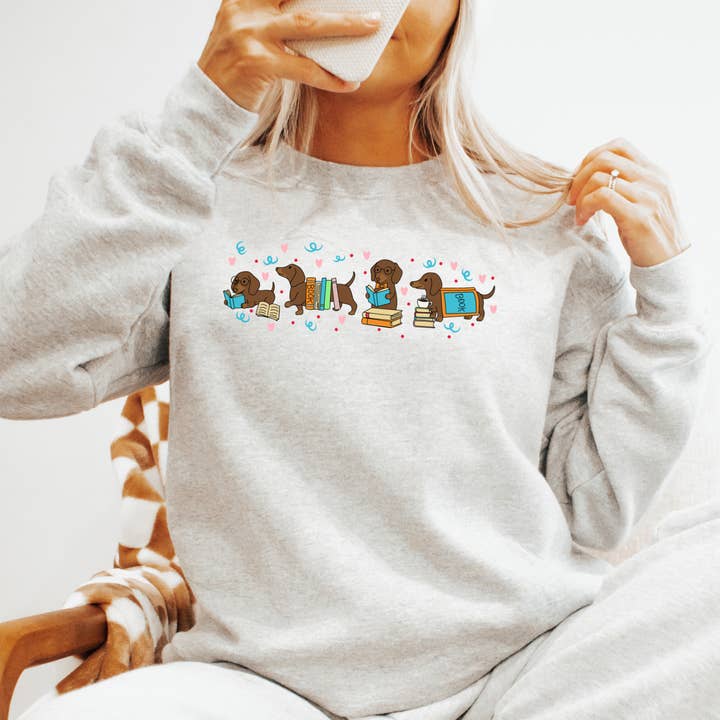 Cute Reading Dachshund Graphic Sweatshirt for wholesale by The Boho Haus