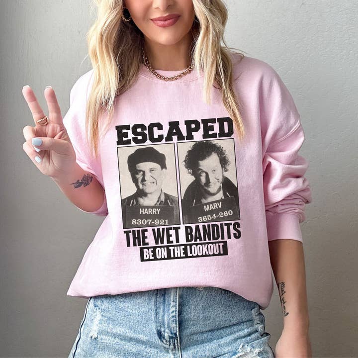 NVC Ecommerce LLC - Wholesale Graphic Sweatshirt - Women's - Retro Home Alone Escaped Mugshots The Wet Bandits Sweatshirt