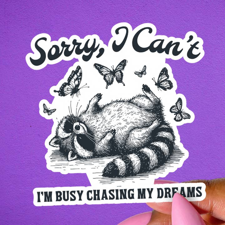 Funny Raccoon Sticker, I Can’t I’m Chasing My Dreams for wholesale by Pretty Toxic Stickers