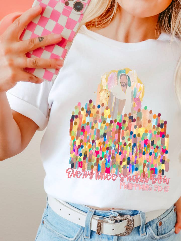 Every Knee Shall Bow Christian Graphic Shirt | Comfort Color and other Purchase Wholesale easter tee. Free Returns & Net 60 Terms on Faire trending on Faire.
