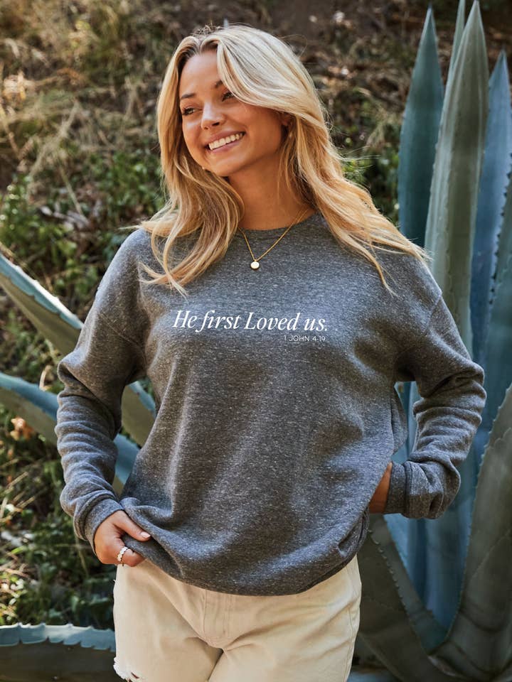 HE FIRST LOVED US 1 JOHN 4:19 Graphic Sweatshirt for wholesale by OAT COLLECTIVE