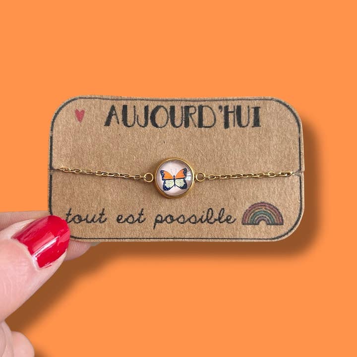 Orange butterfly bracelet, gold or silver finish for wholesale by Dans l'Air du Temps Bijoux