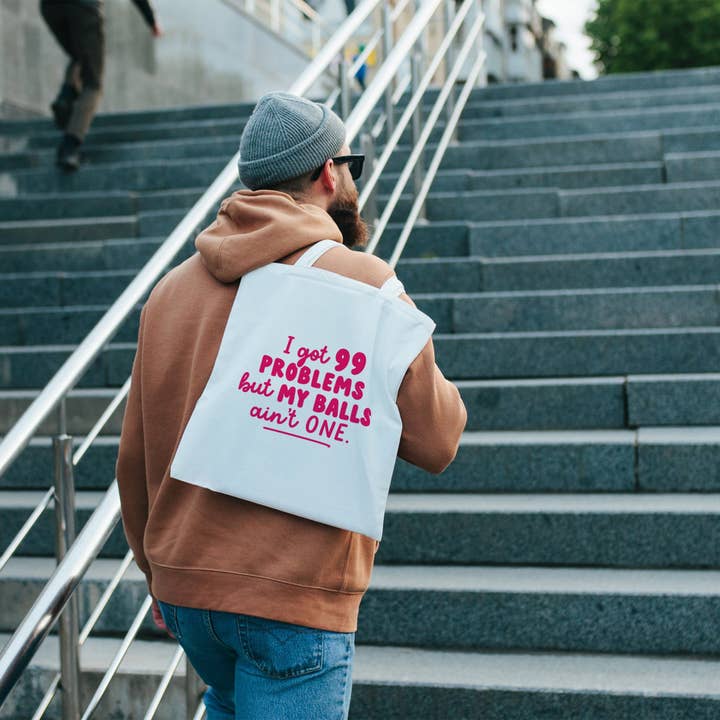 99 Problems But My Balls Ain't One Tote Bag for wholesale by Fighty Pants.
