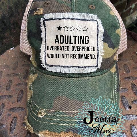 Distressed trucker hat with Adulting fringed patch for wholesale by Joetta Marie