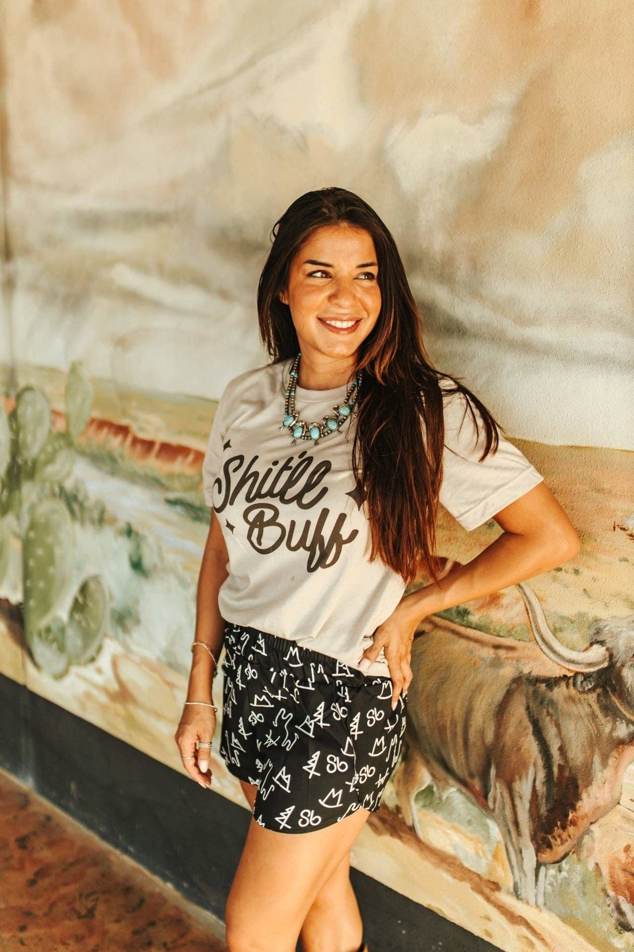 Cool Grey Shit'll Buff Graphic Tee for wholesale on Faire