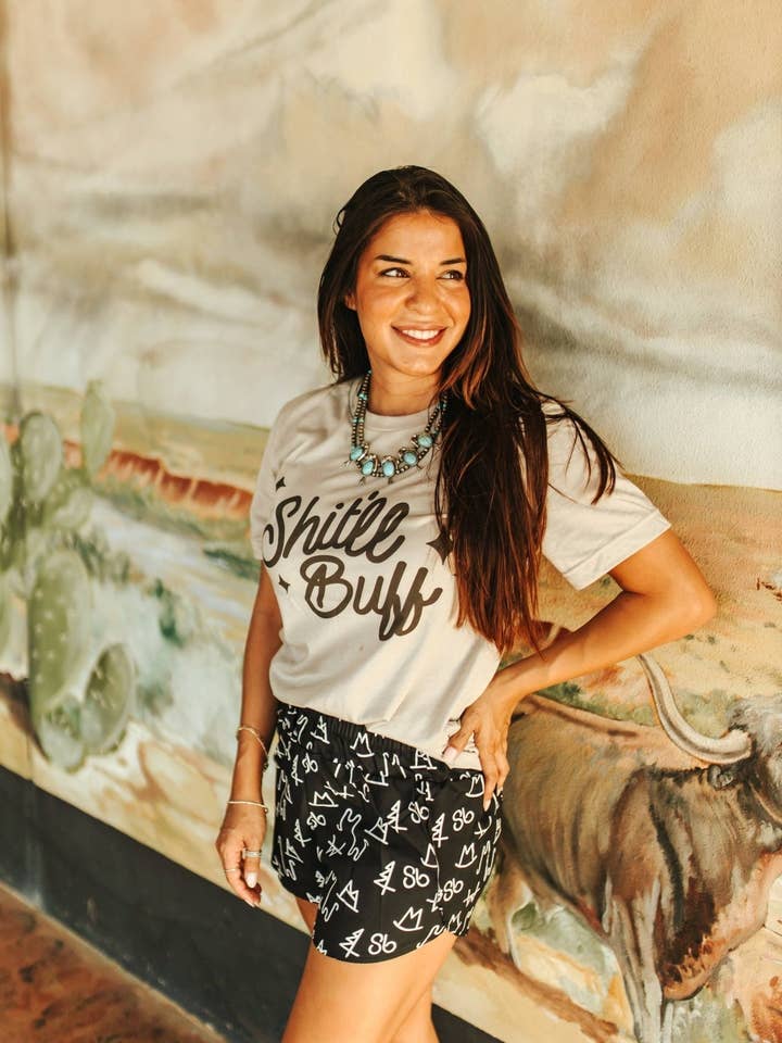 Cool Grey Shit'll Buff Graphic Tee for wholesale on Faire0