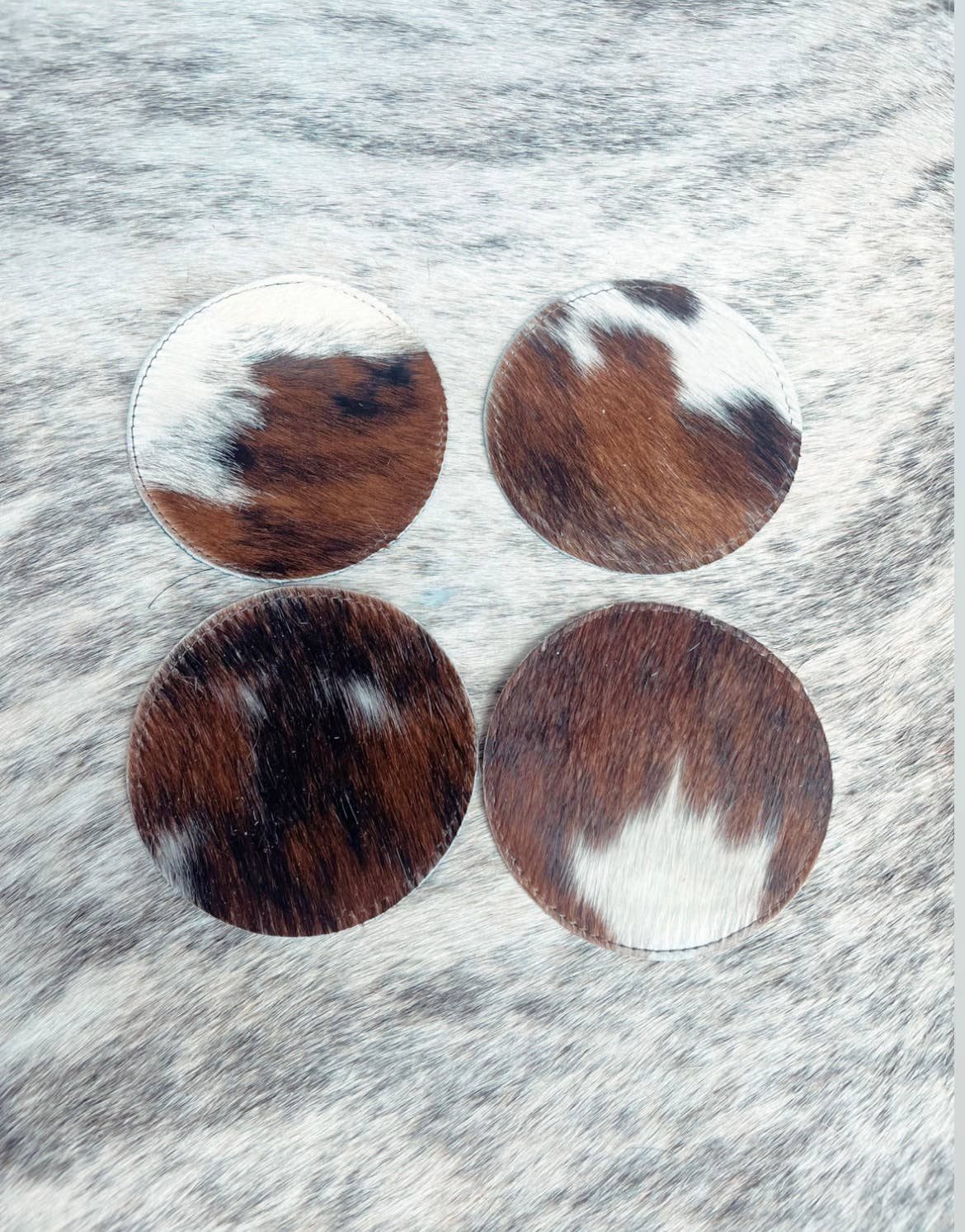 Wholesale Classic Cowhide Coasters 4pc Set for your store Faire