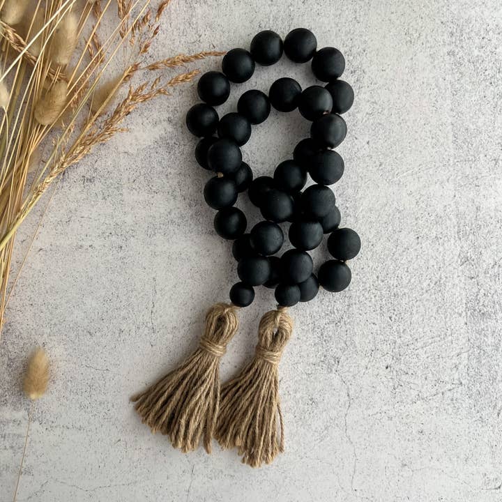 Chuncky black wood bead garland with tassels for wholesale by Deco Azul