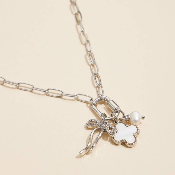 Gold Dipped Bow Charm Necklace with Clover and Pearl for wholesale on Faire
