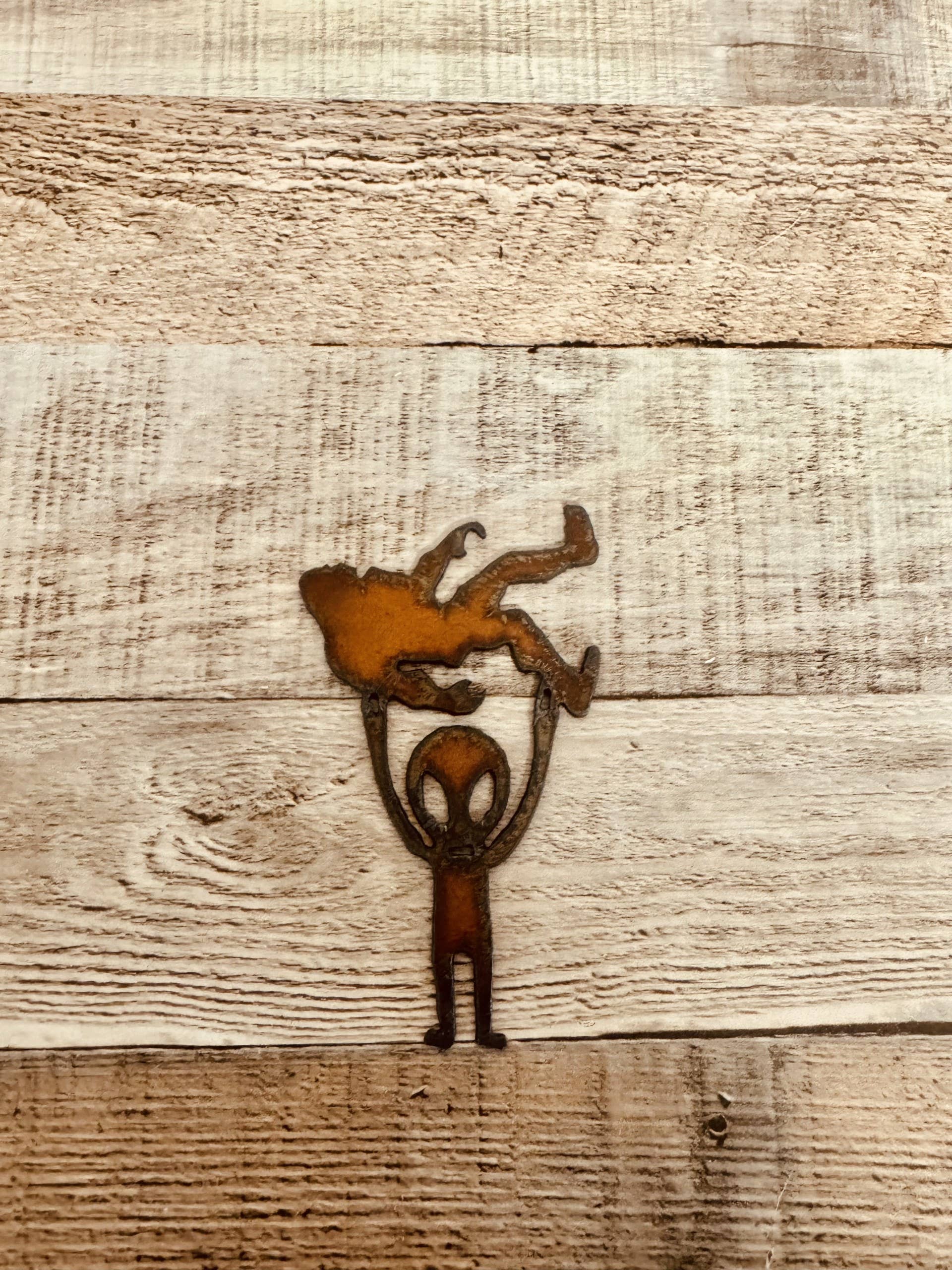 Universal Ironworks USA - Wholesale Magnet - Alien Holding Bigfoot Rustic Metal Magnet Made in USA1