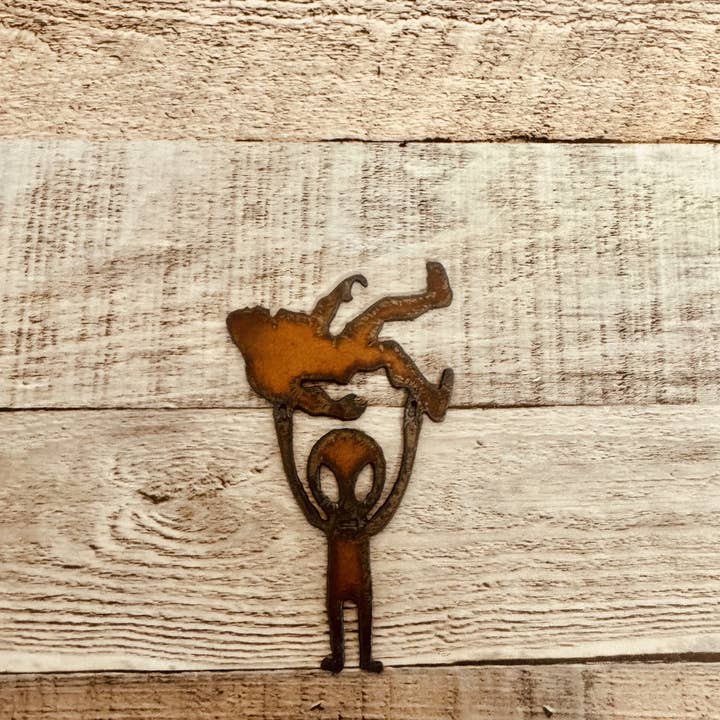 Universal Ironworks USA - Wholesale Magnet - Alien Holding Bigfoot Rustic Metal Magnet Made in USA1