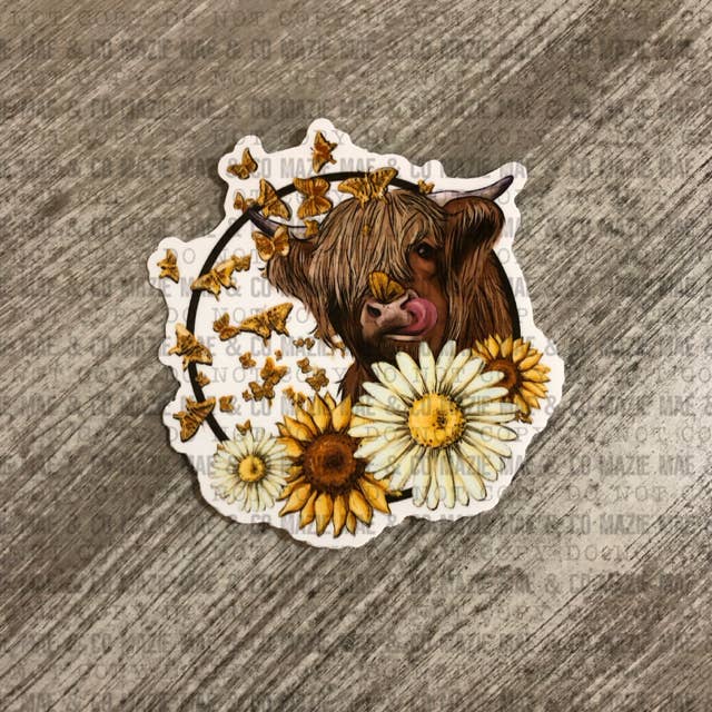 Highland Cow with Daisies Sticker for wholesale by Mazie Mae & Co