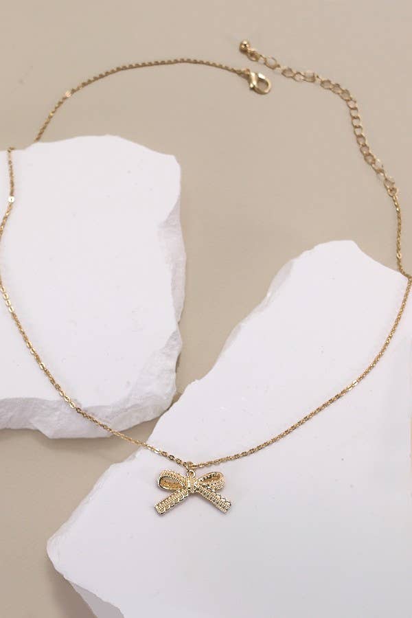 Gold LACE BOW CHARM PENDANT NECKLACE | 80N834 for wholesale on Faire1
