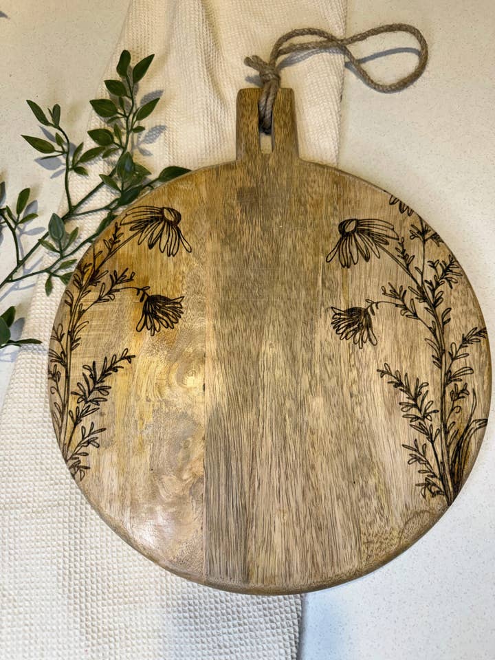 11" Floral Laser Engraved Round Mango Wood Cutting Board for wholesale by House of Wren