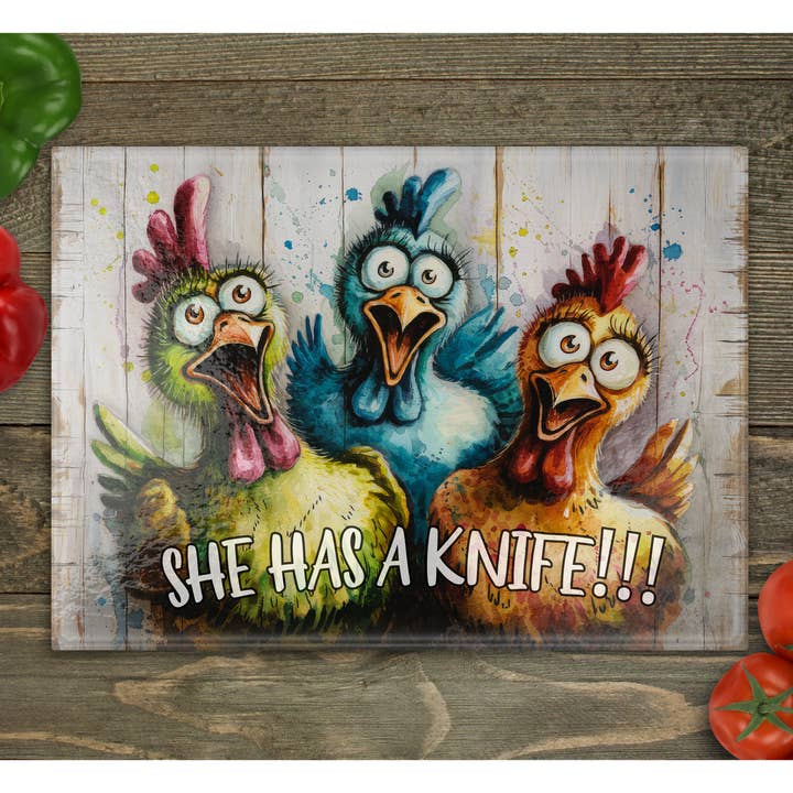 Scared Chickens "She has a kn!fe" Glass Cutting Board for wholesale by Beautiful Creations by Laney